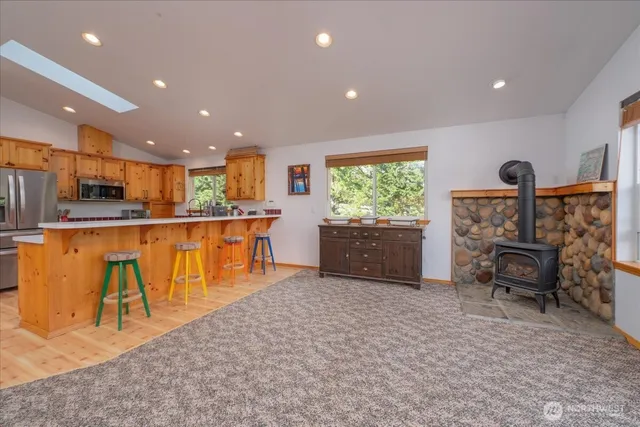 a kitchen with stainless steel appliances kitchen island granite countertop a refrigerator and a sink