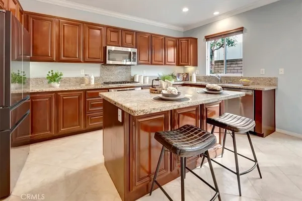 a kitchen with a sink cabinets and window
