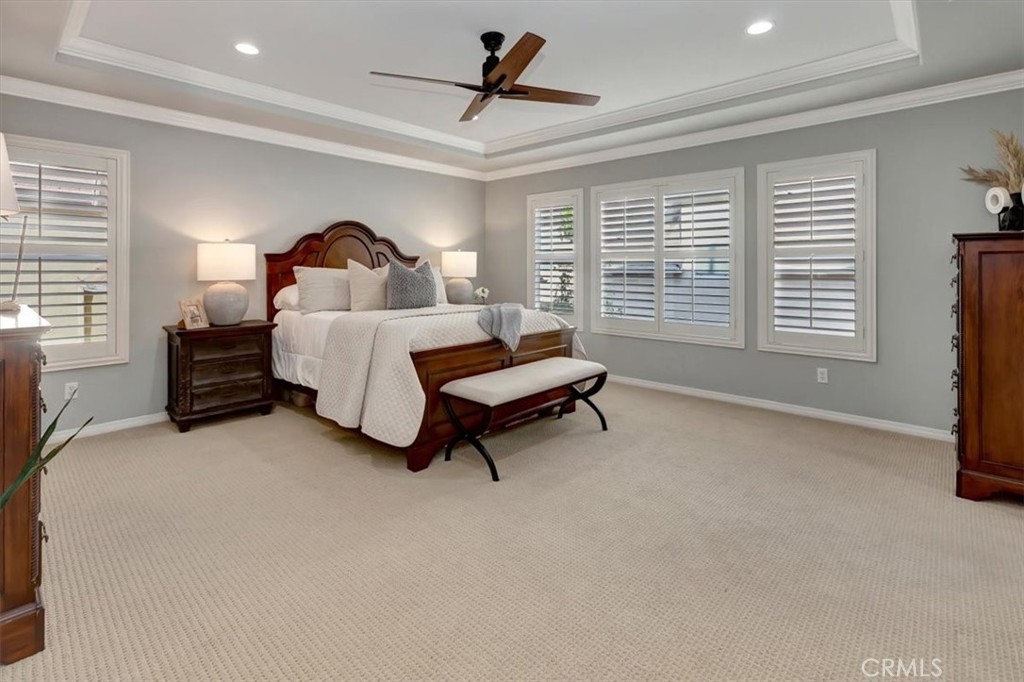 958 Baxter Parkway Brea, CA 92821 - Photo 21 of 50 a spacious bedroom with a bed a chandelier and windows