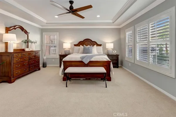 a bedroom with a bed and a lamp on dresser