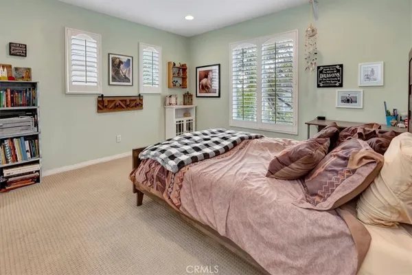 a bedroom with bed and a window