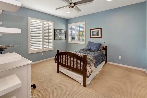 a bed sitting in a bedroom next to a window