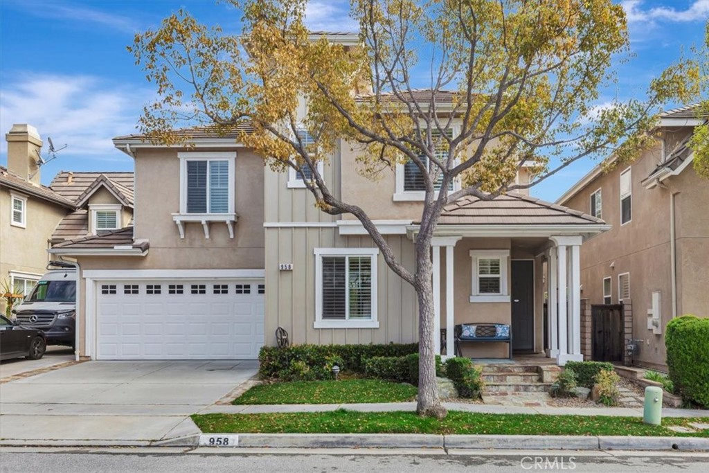 958 Baxter Parkway Brea, CA 92821 - Photo 3 of 50 a view of a white house with a large tree and a yard