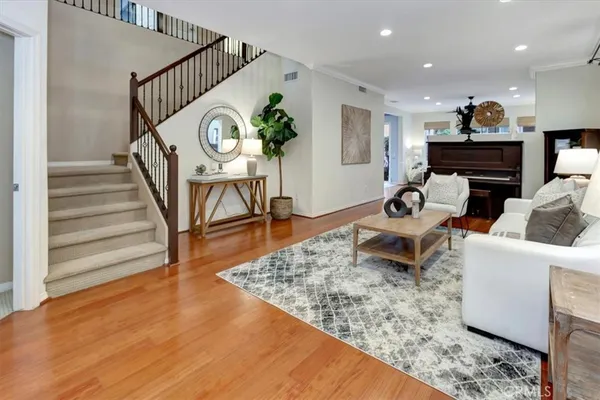 a living room with furniture and a wooden floor
