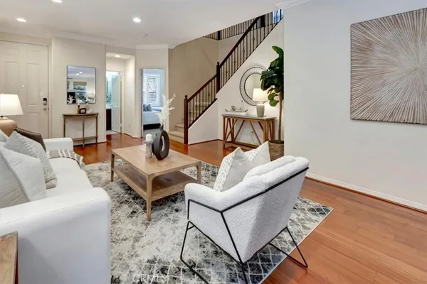 a living room with furniture and wooden floor