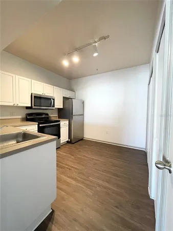 a kitchen with stainless steel appliances a refrigerator and a stove top oven