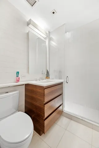 a bathroom with a sink toilet vanity and tub