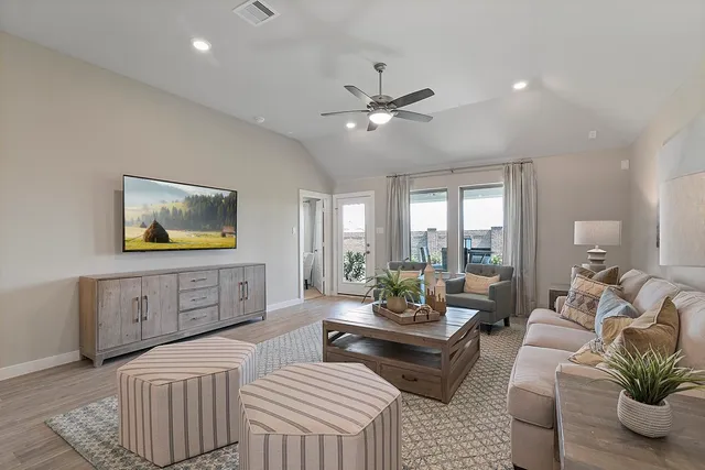 a living room with furniture and a flat screen tv