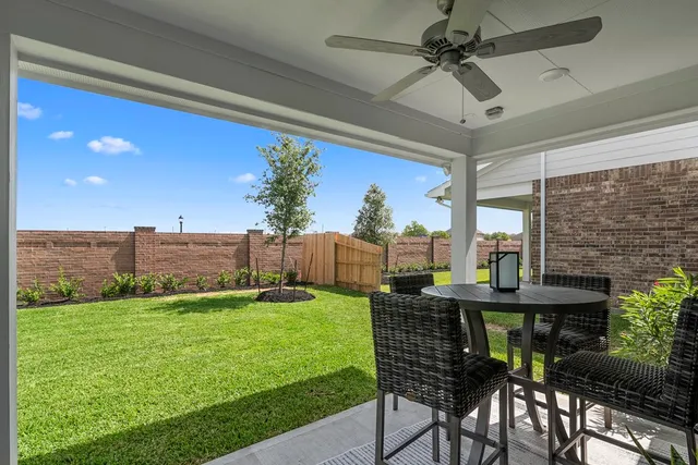 a view of a chairs and table in patio with a yard