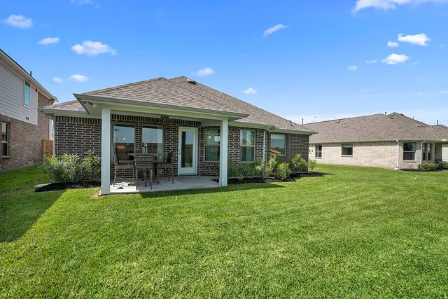 a front view of a house with a yard and porch