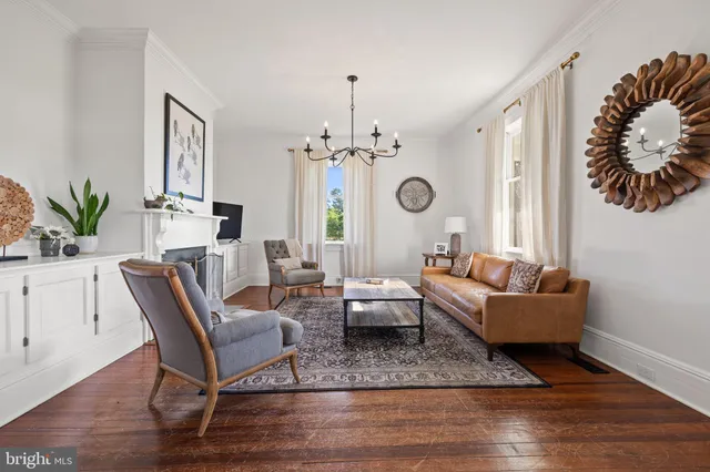 a spacious bedroom with a bed and a chandelier