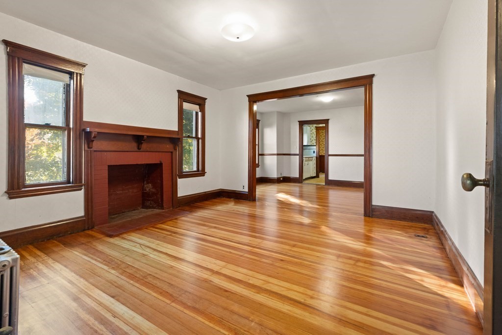 3 Station Road Salem, MA 01970 - Photo 4 of 40 a view of empty room with wooden floor and fireplace