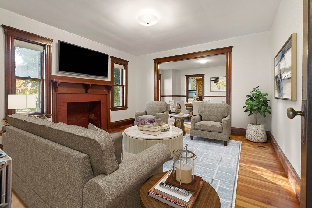 3 Station Road Salem, MA 01970 - Photo 5 of 40 a living room with furniture a fireplace and a flat screen tv