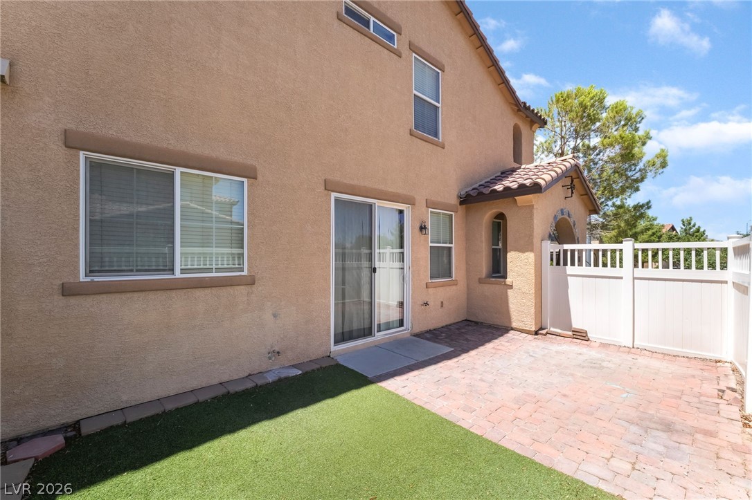 3175 Via Seranova Henderson, NV 89044 - Photo 36 of 45 This private patio area offers a seamless blend of artificial turf and brick pavers, ideal for outdoor enjoyment.