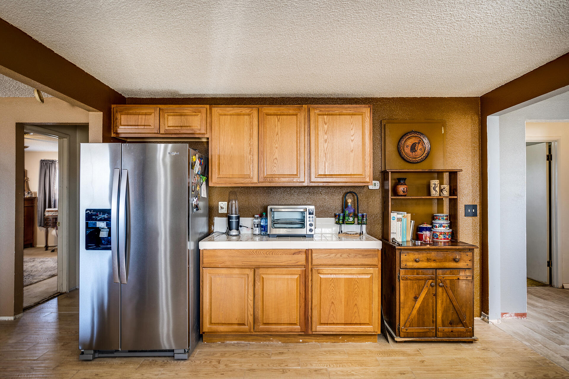 64626 Del Rey Road Joshua Tree, CA 92252 - Photo 11 of 33 a kitchen with stainless steel appliances granite countertop a refrigerator a stove and a sink with large cabinets