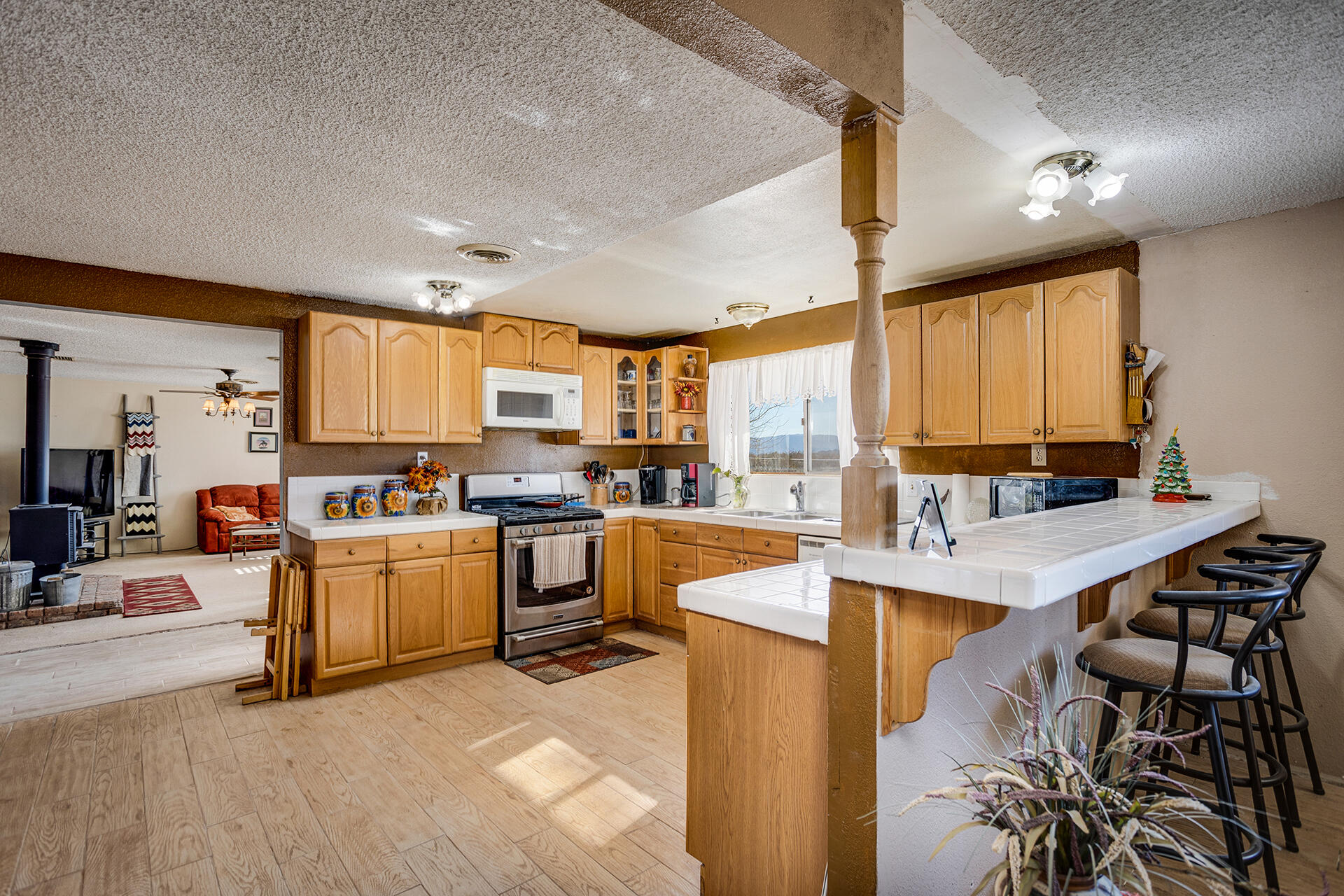 64626 Del Rey Road Joshua Tree, CA 92252 - Photo 12 of 33 a kitchen with stainless steel appliances kitchen island granite countertop a sink and cabinets