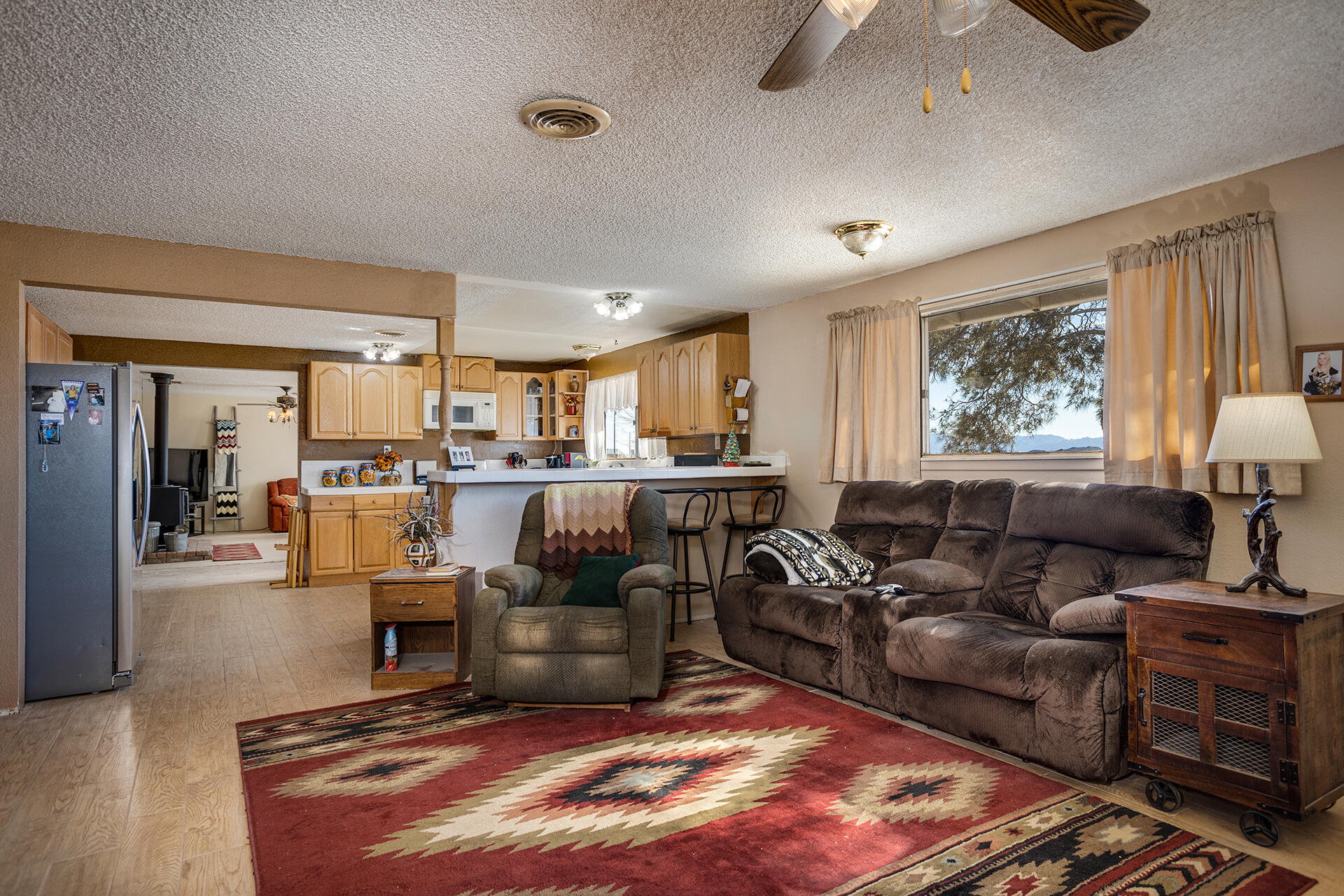 64626 Del Rey Road Joshua Tree, CA 92252 - Photo 13 of 33 a living room with furniture kitchen view and a large window