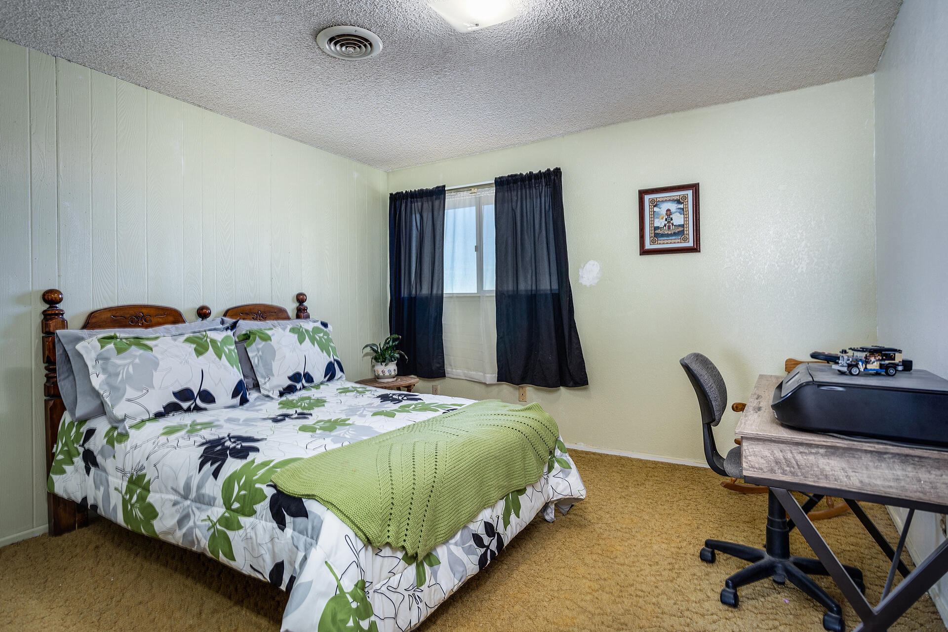 64626 Del Rey Road Joshua Tree, CA 92252 - Photo 20 of 33 a bedroom with a bed and a chair