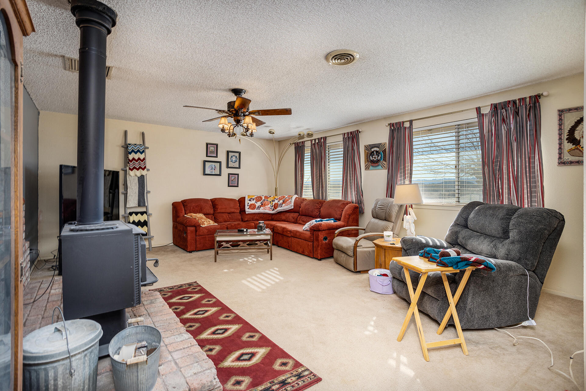 64626 Del Rey Road Joshua Tree, CA 92252 - Photo 8 of 33 a living room with furniture a flat screen tv and a window