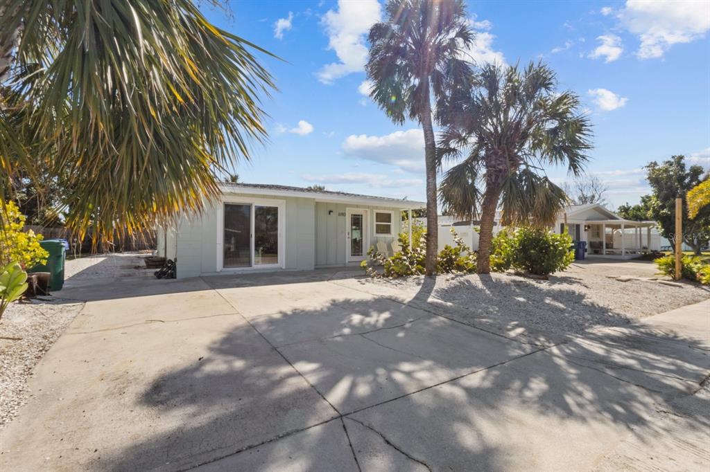 690 Fox Street Longboat Key, FL 34228 - Photo 1 of 41 a view of a house with a yard and palm trees