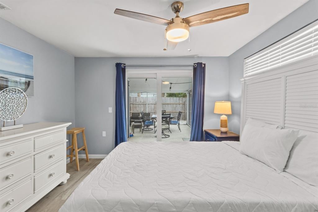 690 Fox Street Longboat Key, FL 34228 - Photo 11 of 41 a bedroom with a bed and a chandelier