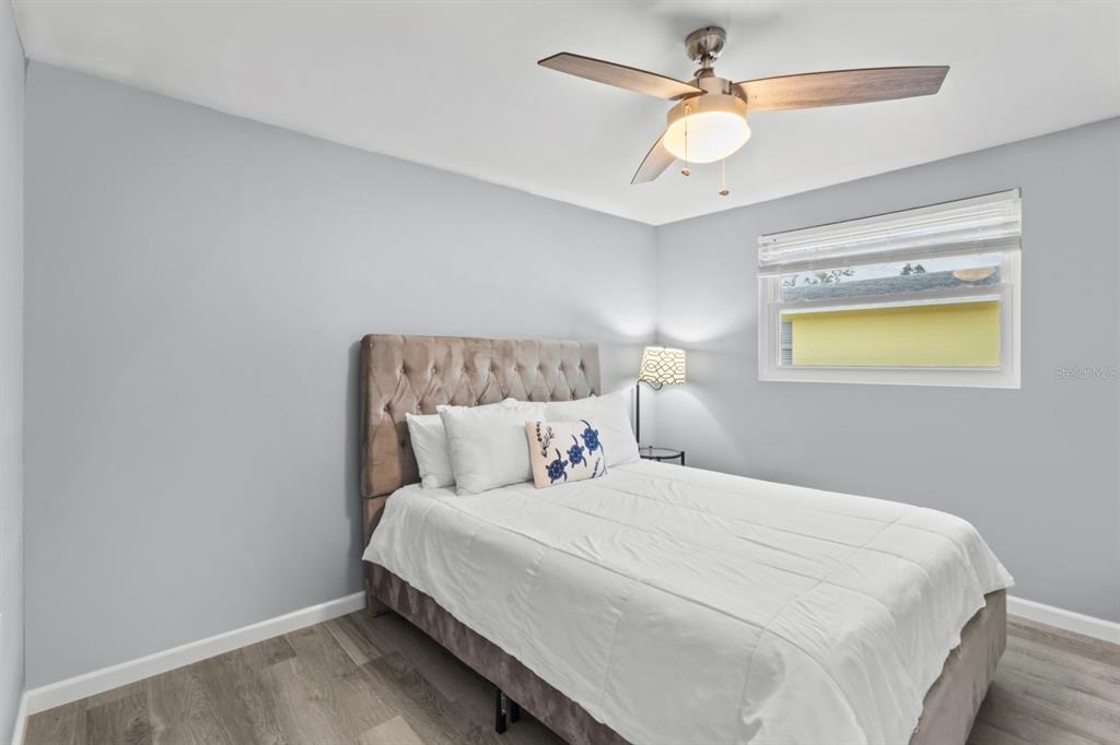 690 Fox Street Longboat Key, FL 34228 - Photo 14 of 41 a bedroom with a bed and a chandelier