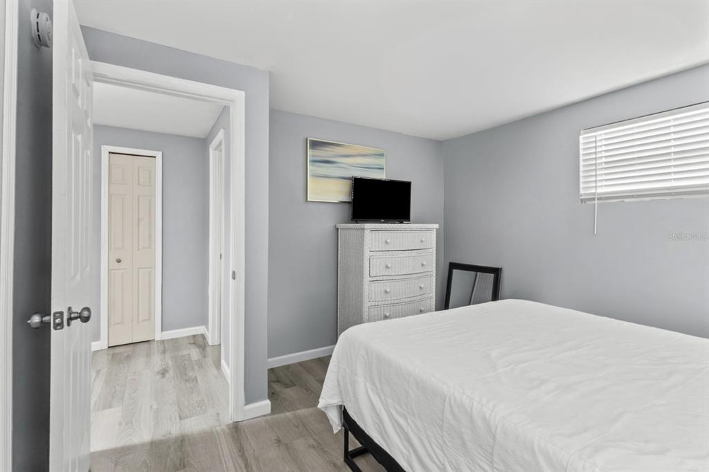 690 Fox Street Longboat Key, FL 34228 - Photo 16 of 41 a bedroom with a bed and a flat screen tv