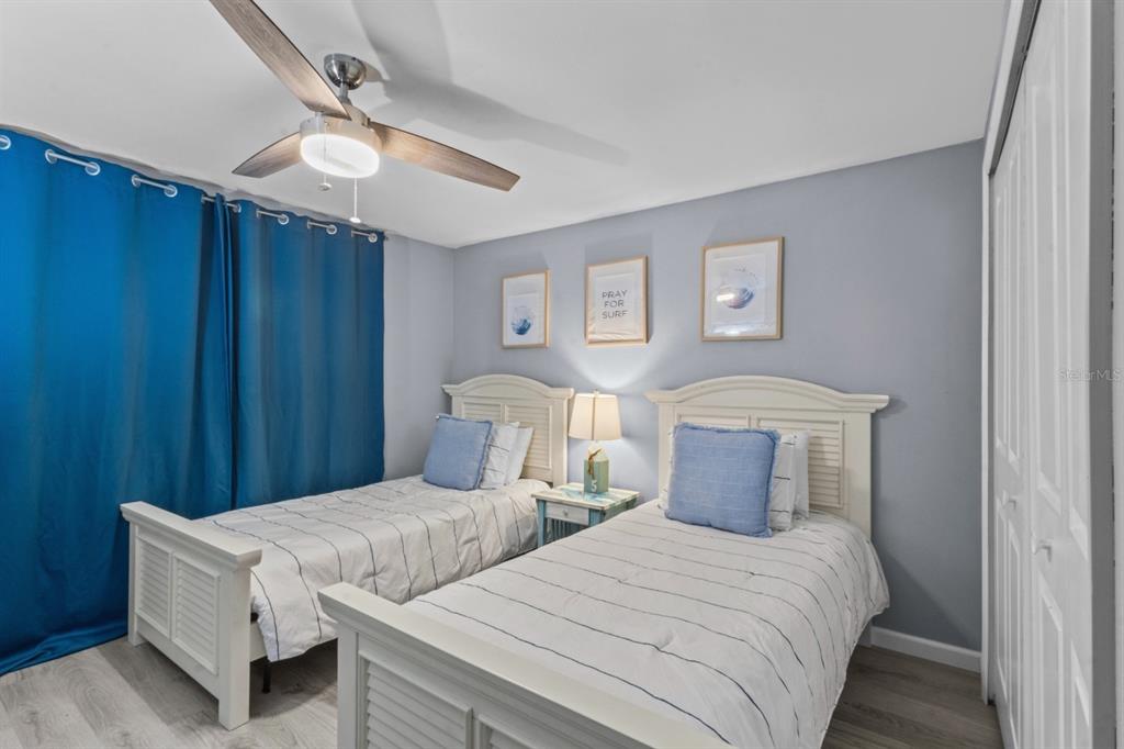 690 Fox Street Longboat Key, FL 34228 - Photo 18 of 41 a bedroom with two beds and a chandelier