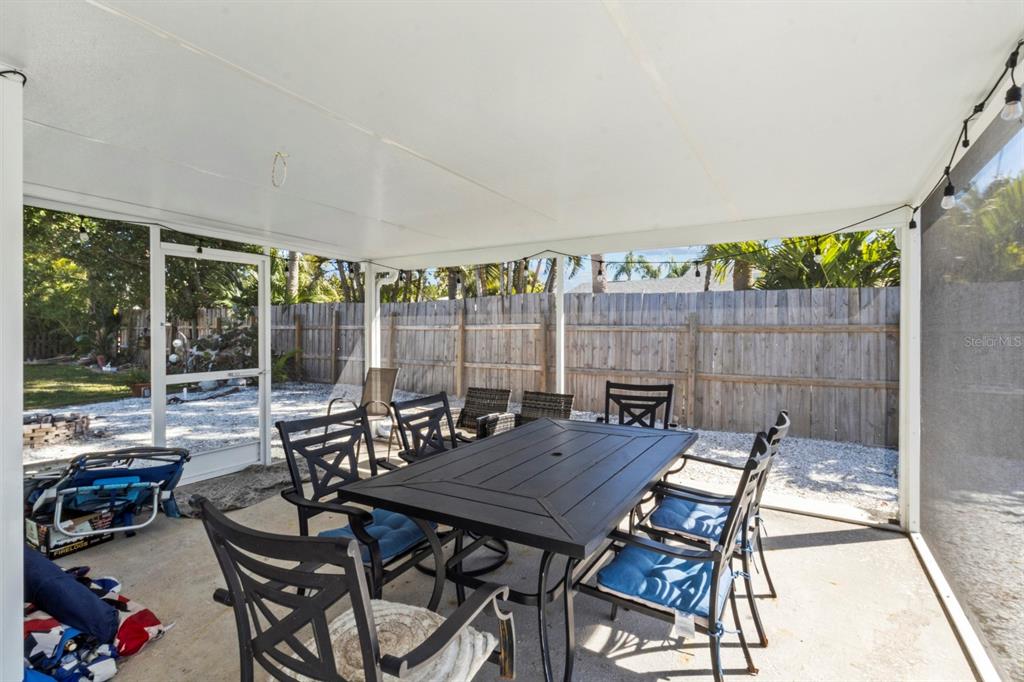 690 Fox Street Longboat Key, FL 34228 - Photo 21 of 41 a view of a patio with a dining table and chairs