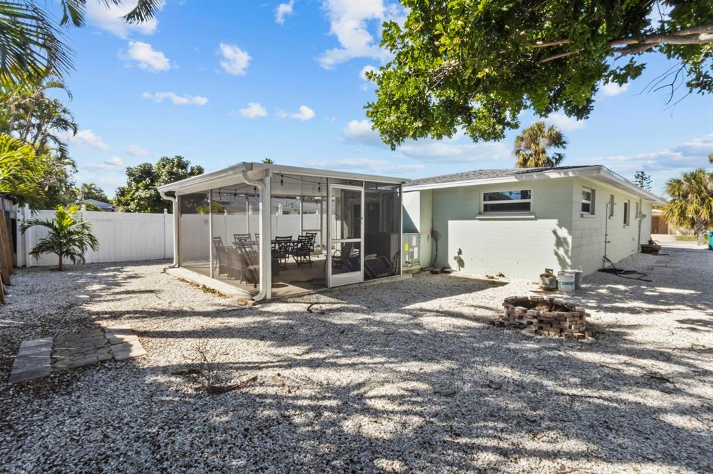 690 Fox Street Longboat Key, FL 34228 - Photo 22 of 41 a backyard of a house with table and chairs