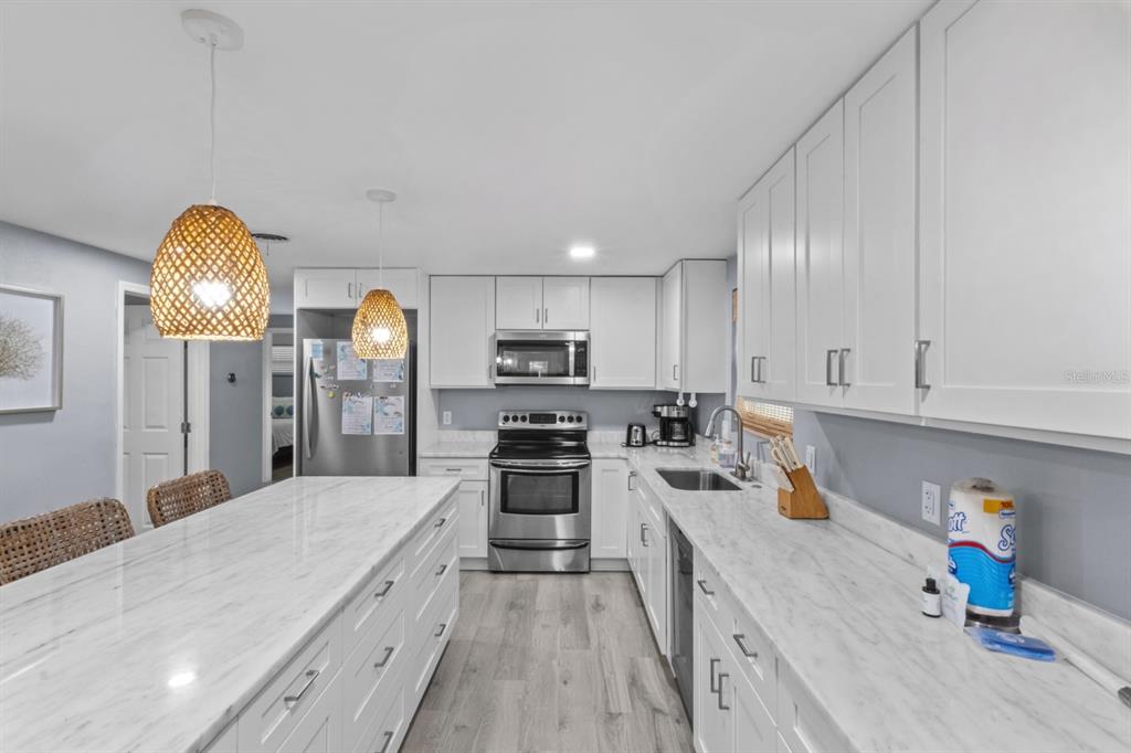 690 Fox Street Longboat Key, FL 34228 - Photo 3 of 41 a kitchen with stainless steel appliances granite countertop a sink dishwasher stove and refrigerator