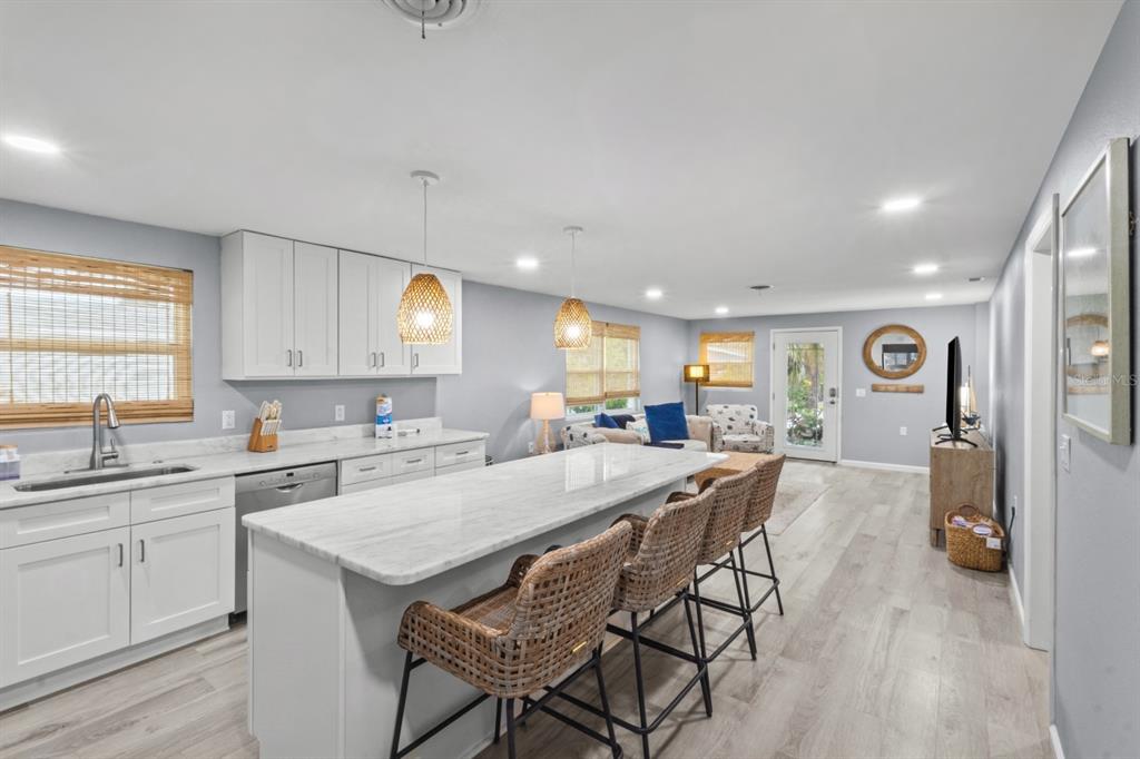 690 Fox Street Longboat Key, FL 34228 - Photo 5 of 41 a kitchen with a table chairs refrigerator and cabinets