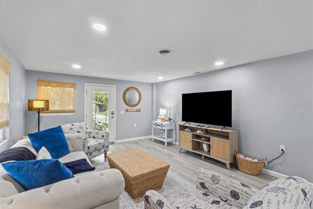 690 Fox Street Longboat Key, FL 34228 - Photo 6 of 41 a living room with furniture and a flat screen tv