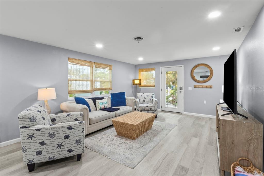 690 Fox Street Longboat Key, FL 34228 - Photo 7 of 41 a spacious bedroom with furniture and a flat screen tv