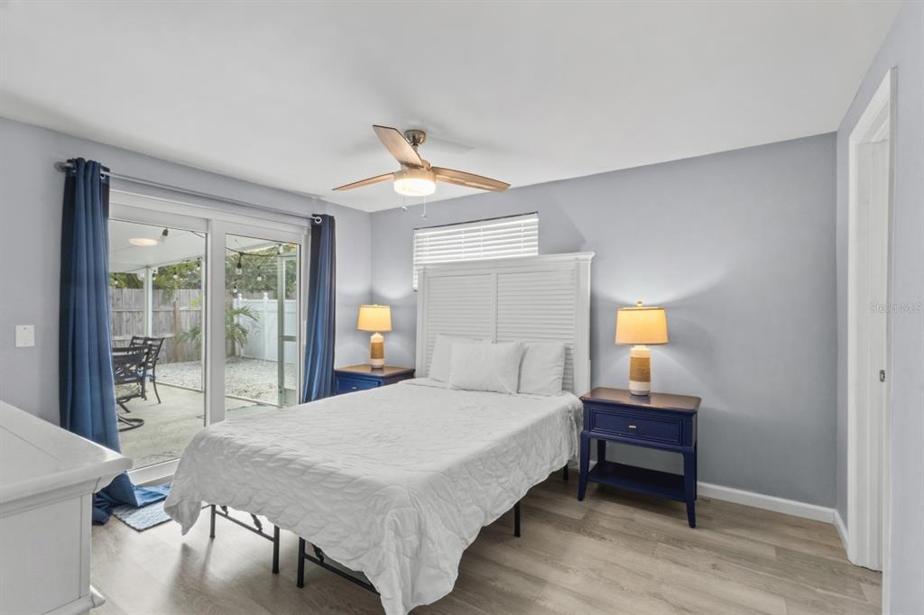 690 Fox Street Longboat Key, FL 34228 - Photo 10 of 41 a bedroom with a bed lamp and a large window