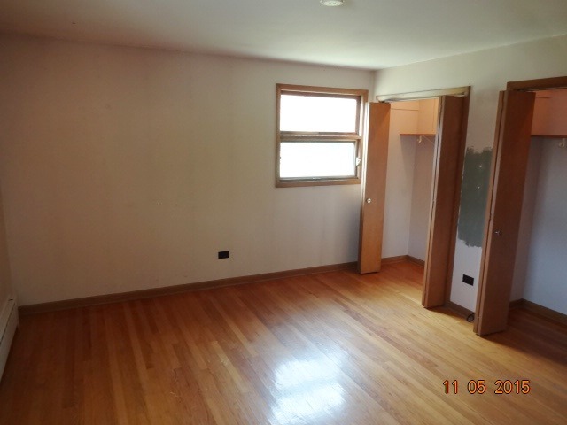 29440 South Klemme Road Beecher, IL 60401 - Photo 8 of 12 an empty room with wooden floor and a window