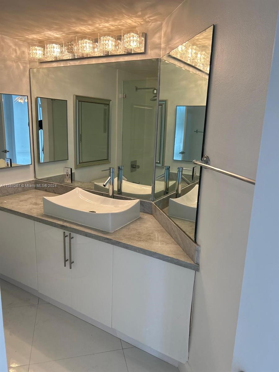 701 Brickell Key Boulevard, Unit 202 Miami, FL 33131 - Photo 15 of 27 a bathroom with a sink and a mirror