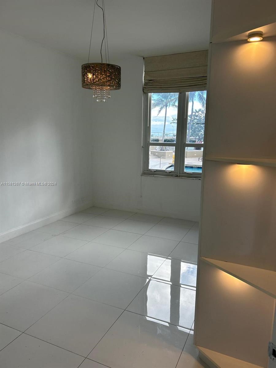 701 Brickell Key Boulevard, Unit 202 Miami, FL 33131 - Photo 27 of 27 en empty room with windows and cabinet