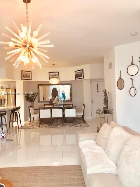 701 Brickell Key Boulevard, Unit 202 Miami, FL 33131 - Photo 4 of 27 a living room with furniture and a chandelier