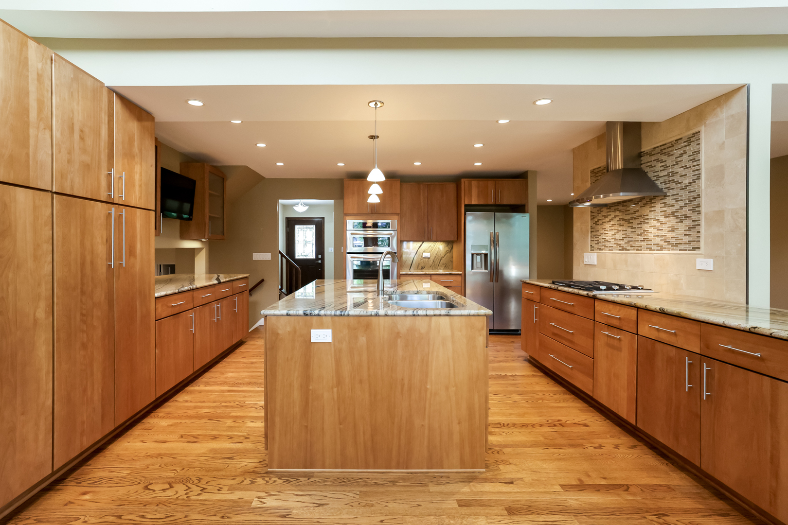 3206 Maple Leaf Drive Glenview, IL 60026 - Photo 13 of 45 a large kitchen with stainless steel appliances kitchen island granite countertop a large counter top and a stove top oven