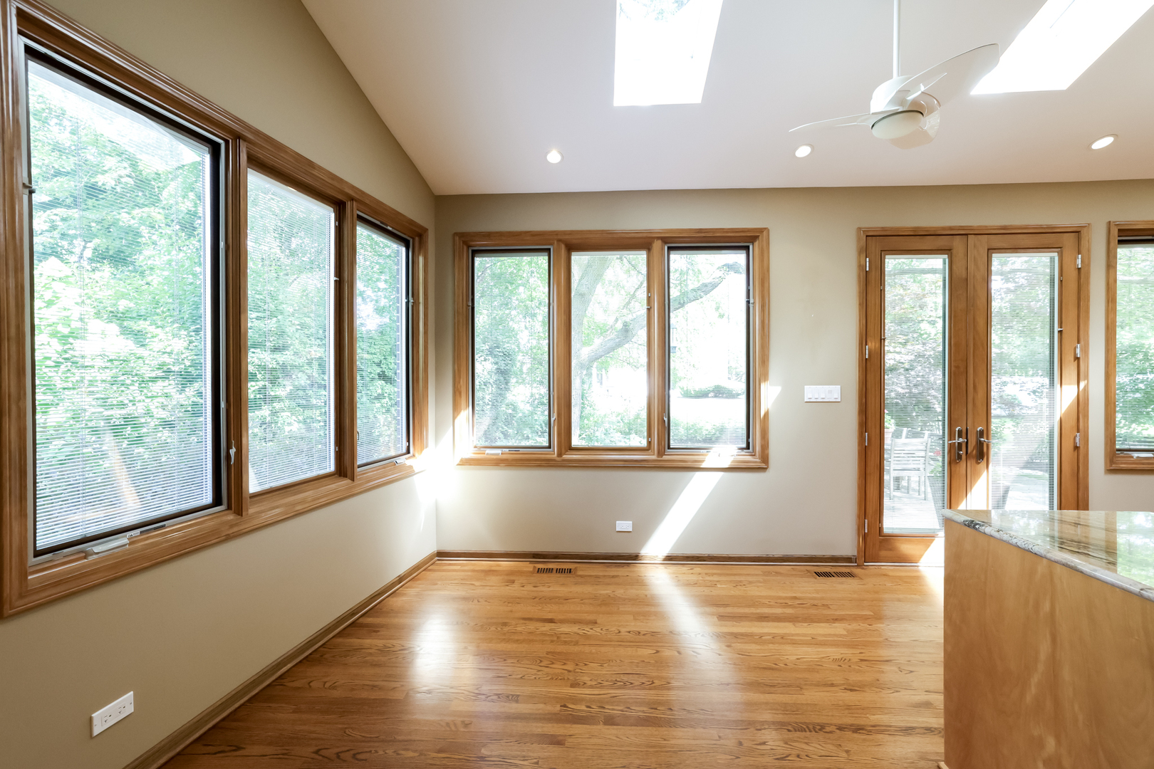 3206 Maple Leaf Drive Glenview, IL 60026 - Photo 17 of 45 a view of an empty room with wooden floor and a window