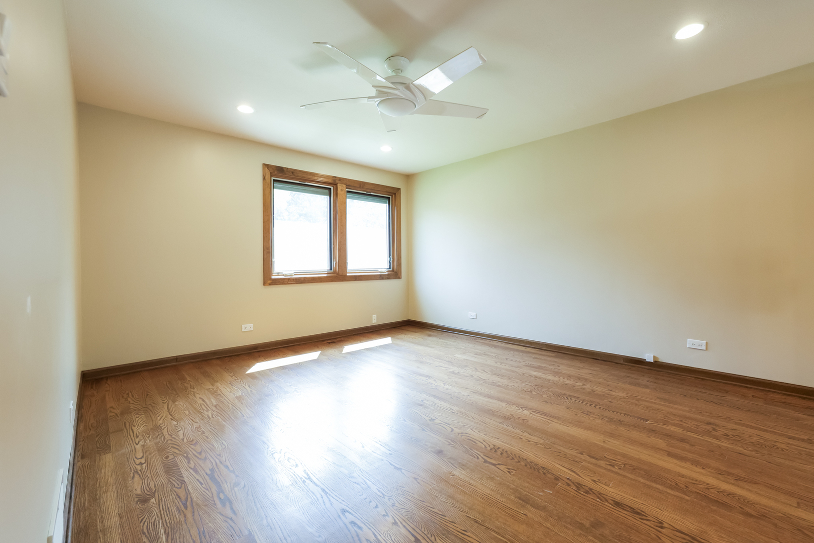 3206 Maple Leaf Drive Glenview, IL 60026 - Photo 25 of 45 an empty room with wooden floor and windows