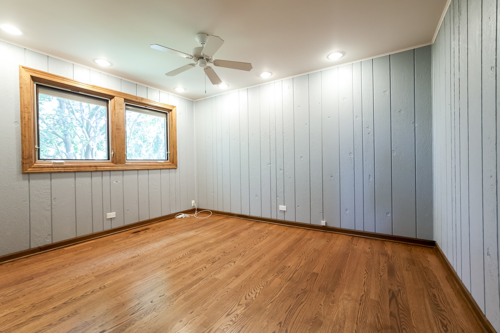 3206 Maple Leaf Drive Glenview, IL 60026 - Photo 27 of 45 a view of an empty room with wooden floor and a window