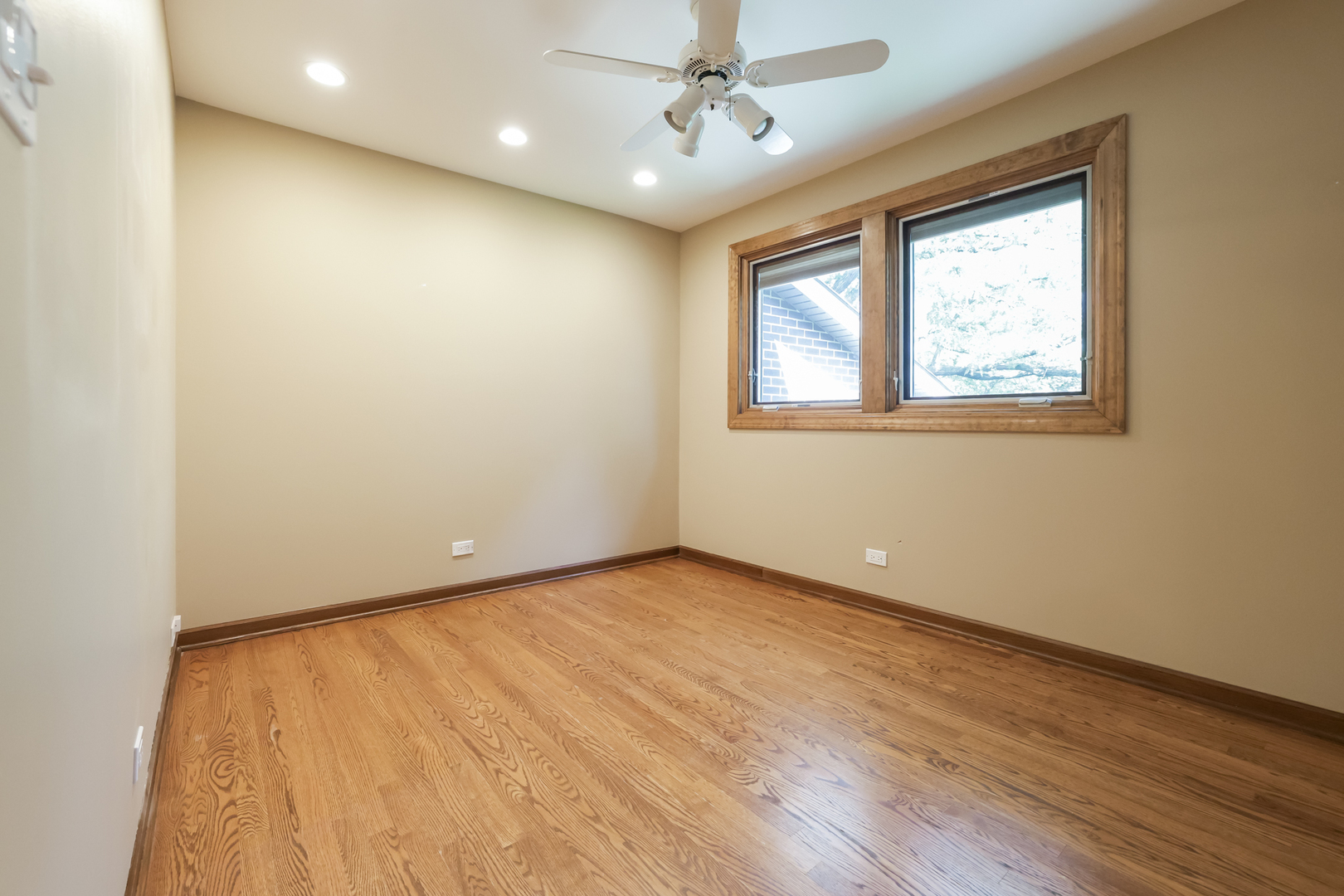 3206 Maple Leaf Drive Glenview, IL 60026 - Photo 29 of 45 an empty room with a window and wooden floor
