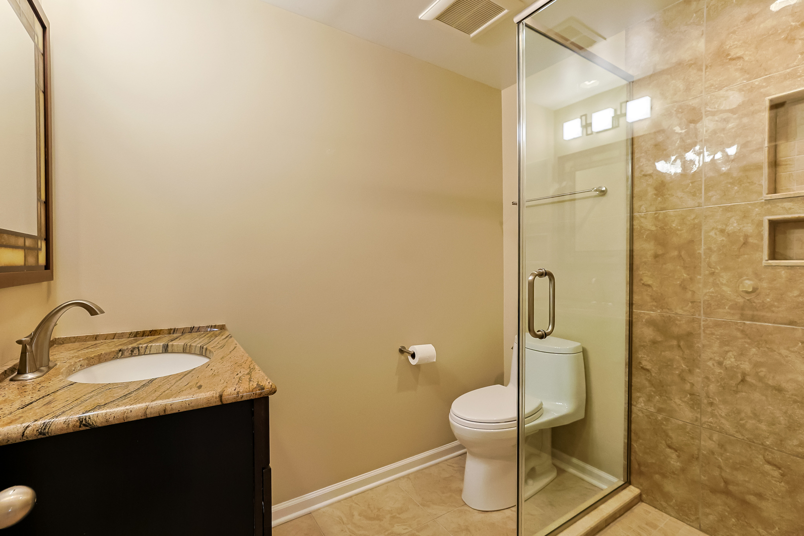 3206 Maple Leaf Drive Glenview, IL 60026 - Photo 39 of 45 a bathroom with a granite countertop sink toilet and a mirror