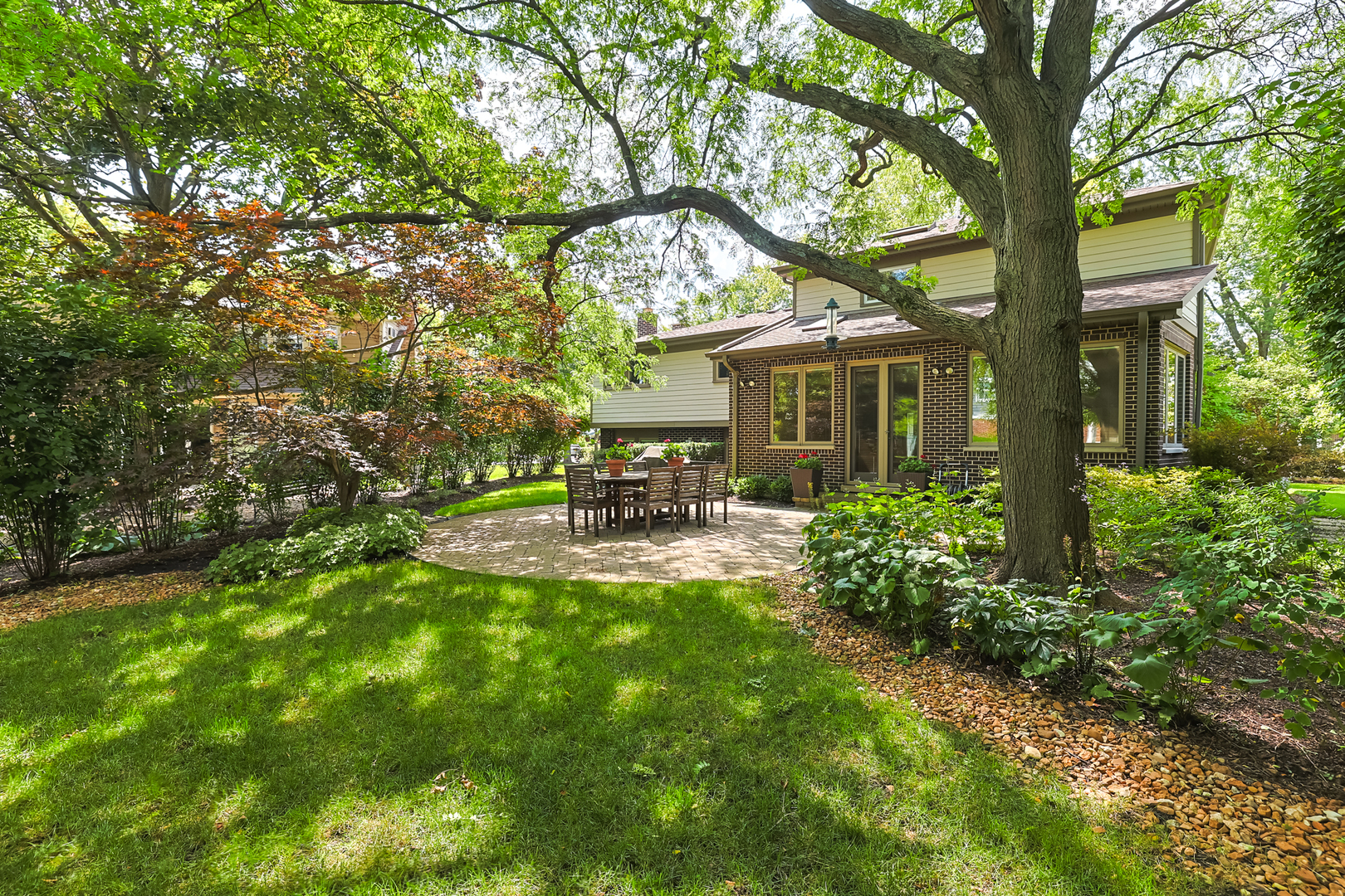 3206 Maple Leaf Drive Glenview, IL 60026 - Photo 45 of 45 a view of patio with a table and chairs under an umbrella