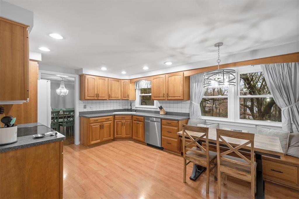 9350 Timber Trail Pittsburgh, PA 15237 - Photo 14 of 38 a kitchen with a table chairs refrigerator and microwave