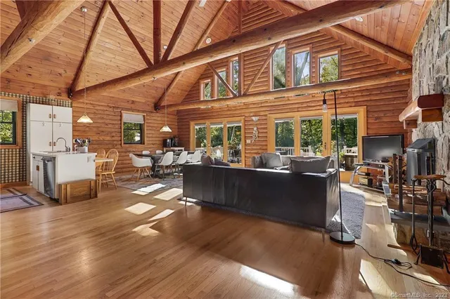 a living room with lots of furniture and kitchen view