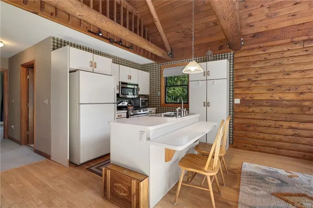a view of kitchen with refrigerator and microwave
