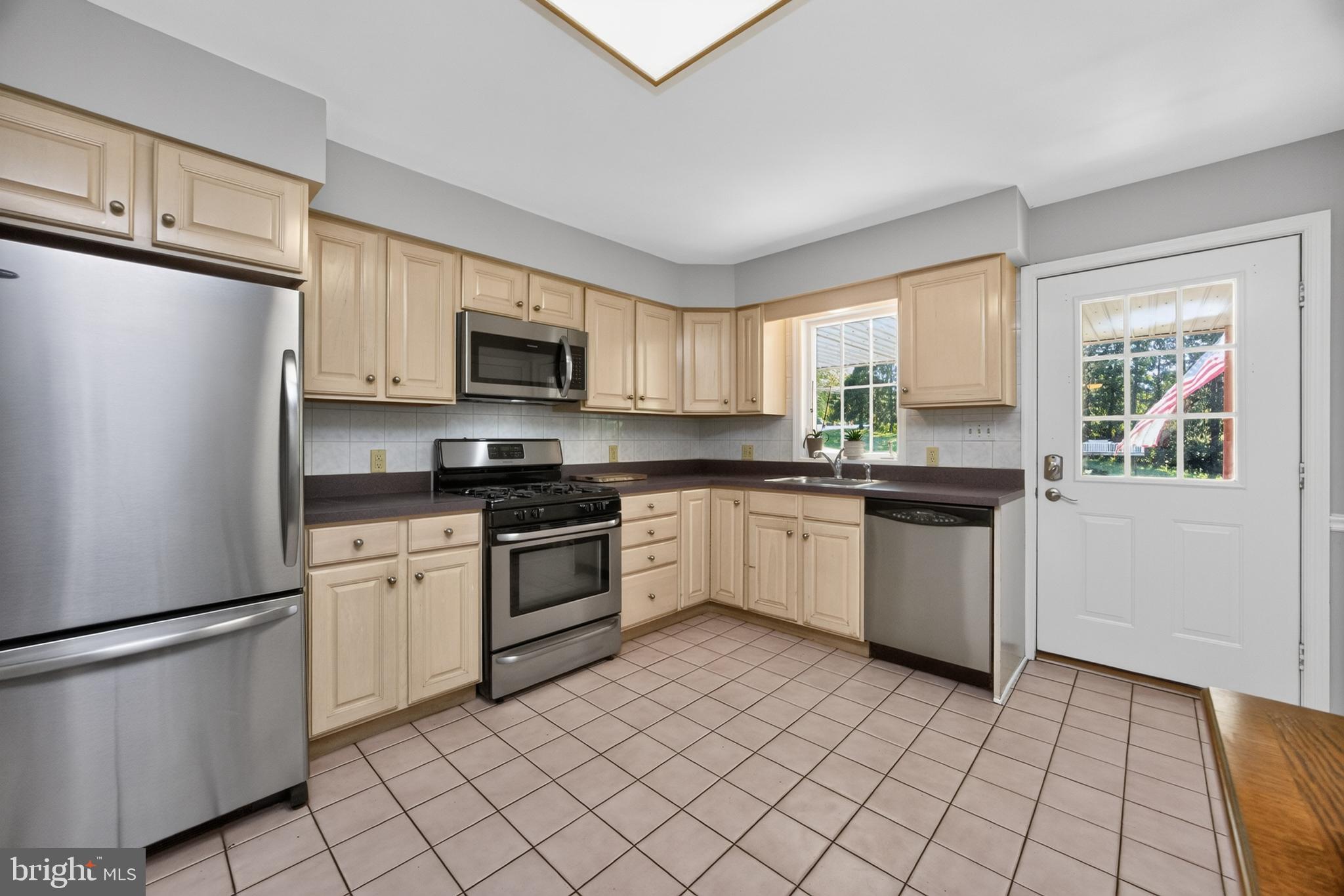 311 Hillendale Road Avondale, PA 19311 - Photo 10 of 40 Kitchen w/side entrance to covered porch & carport